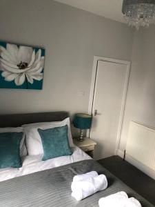 a bedroom with a bed with two towels on it at Number Fifty Six in Hawick