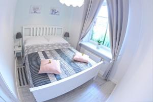 Posteľ alebo postele v izbe v ubytovaní Apartamenty Zamkowa