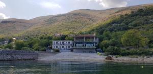 a house on the shore of a body of water at B&B BALANI Rooms in Shkodër