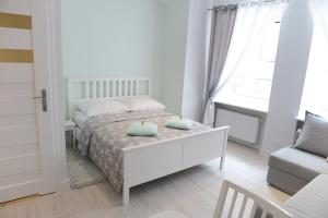 Posteľ alebo postele v izbe v ubytovaní Apartamenty Zamkowa