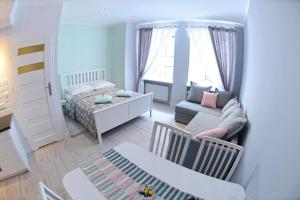 Posteľ alebo postele v izbe v ubytovaní Apartamenty Zamkowa