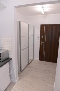 Kuchyňa alebo kuchynka v ubytovaní Apartamenty Zamkowa