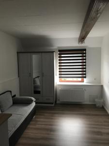 a living room with a couch and a window at Hademarscher Hof in Hanerau-Hademarschen