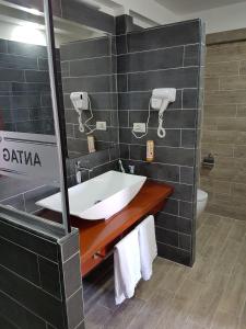 a bathroom with a sink and a mirror at Hotel ANTAG in Shëngjin