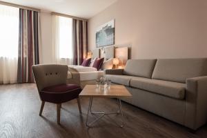 a living room filled with furniture and a couch at Hotel Max 70 in Salzburg