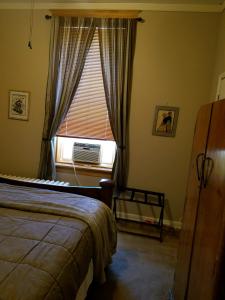 a bedroom with a bed and a window with a air conditioner at The Westland Suite in Chester