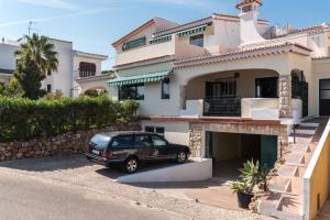 a car parked in front of a house at Quinta da Paz B&B in Portimão