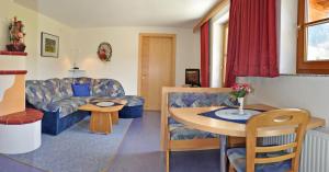 a living room with a couch and a table at Haus Lärchenwald in Niederthai +16 photos
