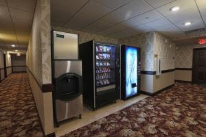 a vending machine in a room with a drink cooler at Arrow Hotel in Broken Bow