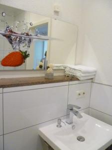 a bathroom with a sink and a mirror at Moderne Wohnung in barockem Altstadthaus nahe Altstadt und Radweg in Blieskastel +33 photos