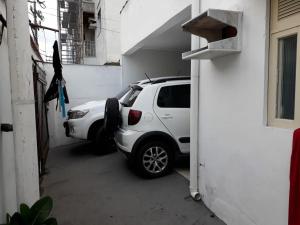a white car parked in a garage next to a building at Casa Praia do Forte in Cabo Frio