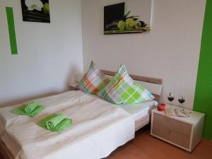 a bedroom with a bed with green towels on it at Nürnberg Apartment 2 in Nuremberg