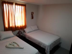 Postel nebo postele na pokoji v ubytování Hostal El Naufrago 1