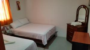 Postel nebo postele na pokoji v ubytování Hostal El Naufrago 1