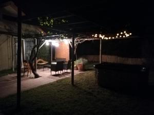a patio at night with a table and chairs at Parcela 9 Nehuen in Talagante