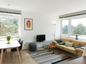 a living room with a couch and a table at Ferienwohnung *Krabbe 25* in Wittdün