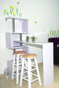 a kitchen with a purple counter and two stools at Qstay Sitiawan Townhouse (Minnie Dreams) - 米妮梦 in Sitiawan
