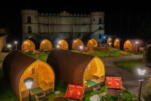 a group of tents in front of a castle at night at Inn-side ADVENTURE CABINS in Haiming
