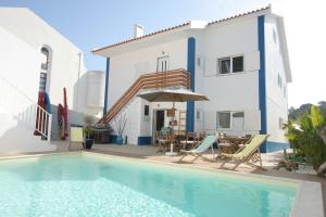 a villa with a swimming pool and a house at Casa Lagoa in Foz do Arelho