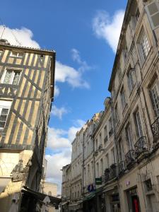 a row of buildings on a street with a blue sky at L'AppaRt in La Rochelle