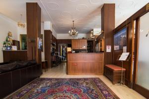 a living room with a rug on the floor at Hotel Marisa in Albenga