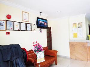 a living room with a tv on a wall at Sun Inns Hotel Sunway Mentari in Petaling Jaya