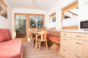 a kitchen with a table and chairs and a couch at Landhaus Maria in Neustift im Stubaital
