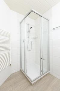 y baño con ducha y puerta de cristal. en Pension Peter, en Neustift im Stubaital