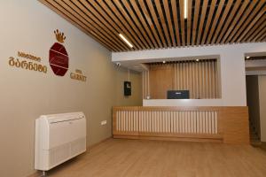 an empty waiting room with a reception desk in a building at Hotel Garnet Tbilisi in Tbilisi City