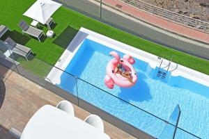 an overhead view of a swimming pool with a person in a life preserver at Beyond Amadores C&H Suite Nº4 in Amadores