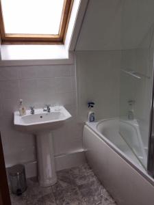 a bathroom with a sink and a bath tub at George's House - 1 Leacklee in Manish