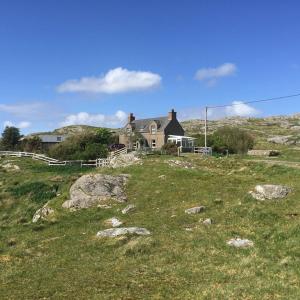 a house sitting on top of a grassy hill at George's House - 1 Leacklee in Manish