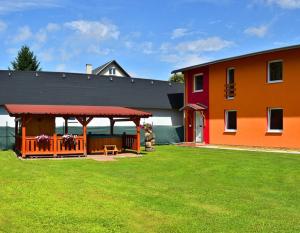 a house with a gazebo next to a yard at Privat Monika in Liptovský Mikuláš