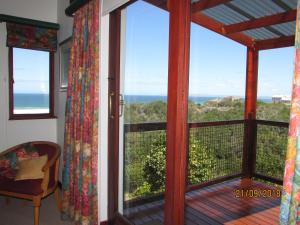 
a view from a balcony of a house with a view of the ocean at Melkhoutkloof Guest House in Outeniqua Strand
