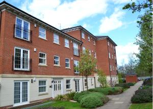 a red brick building with white doors and windows at 2 bed 2 bath at Jago Crt in Newbury - FREE allocated parking in Newbury