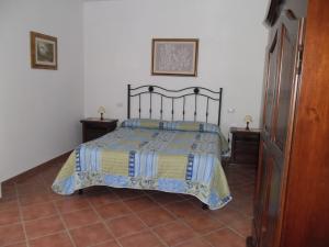 a bedroom with a bed and two night stands at Poggio Petrella in Manciano