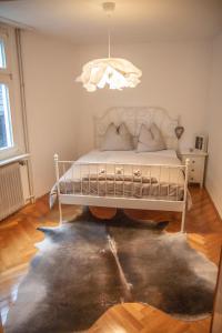 a bedroom with a bed and a rug at VIKARO Apartment in Monschau