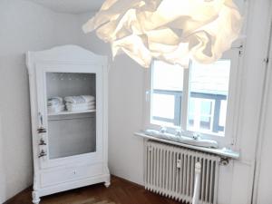 a bathroom with a mirror and a chandelier at VIKARO Apartment in Monschau