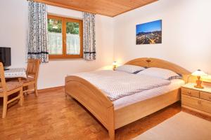 a bedroom with a bed and a desk and a chair at Haus Panoramablick in Abtenau