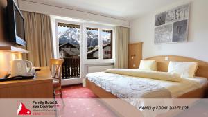 Ένα ή περισσότερα κρεβάτια σε δωμάτιο στο Family Hotel Desirée