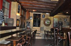 a bar with wooden tables and chairs in a restaurant at Le Port Malo in Saint Malo +15 photos