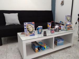 a white table with products on it with a couch at Apollon Apartments H-1 H-2 in Rhodes Town