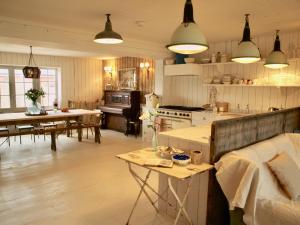 a kitchen and living room with a table and a couch at Beach House. Camber Sands. Sleeps 12 in Camber