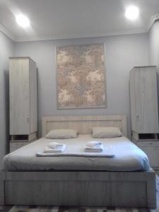 a bedroom with a bed with two towels on it at Guesthouse Kato in Tbilisi City