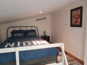 - une chambre avec un lit et un panneau mural dans l'établissement Studio Champagne, à Châlons-en-Champagne