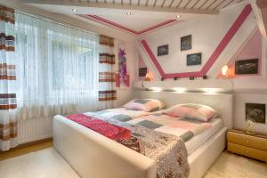 a bedroom with a large bed and a window at Ferienhaus Haus Herzog in Titisee-Neustadt