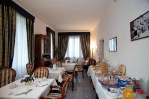 a dining room with two tables and chairs with food on them at Villa Margherita in Levanto