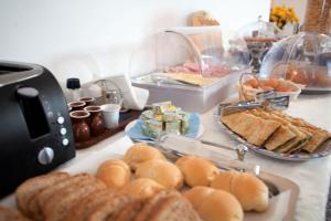 a table with bread and pastries and sandwiches on it at Villa Margherita in Levanto