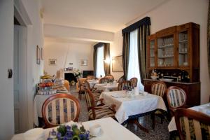 a dining room with tables and chairs in a room at Villa Margherita in Levanto