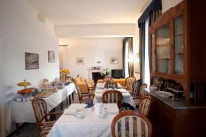 a dining room with tables and chairs in a room at Villa Margherita in Levanto